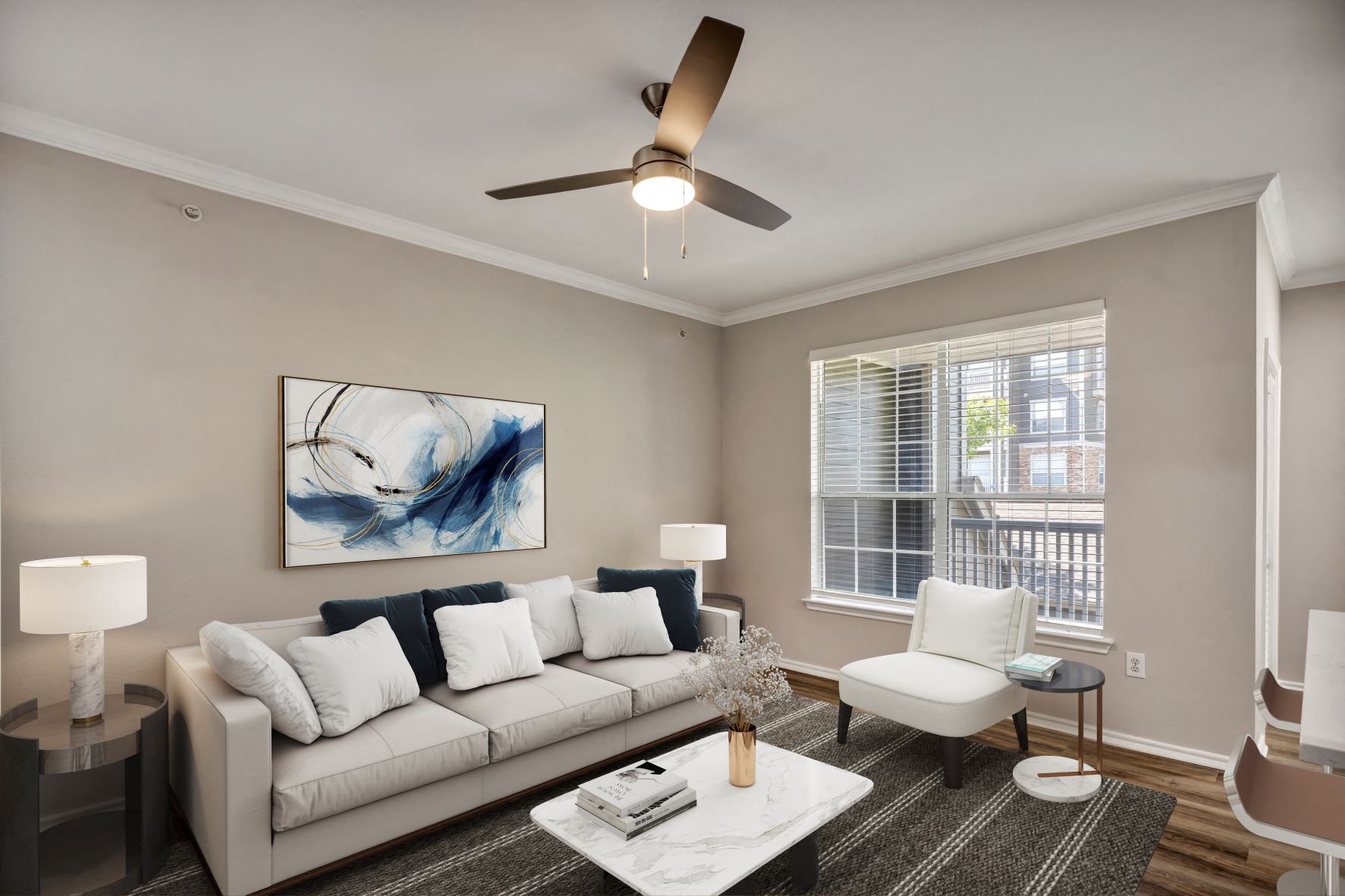 a living room with a white couch and a ceiling fan